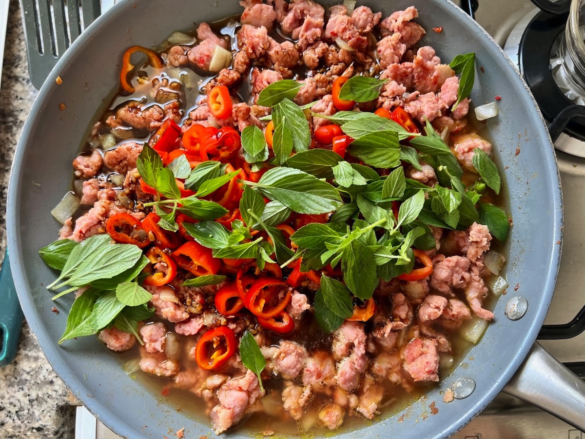 Fresh basil and sliced mini red peppers added to Thai Basil Pork recipe.