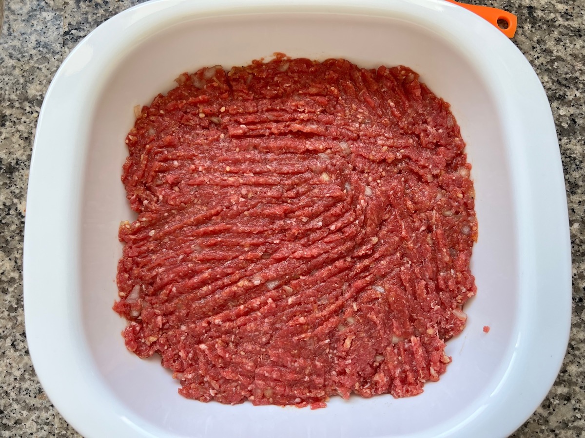 Raw meatloaf meat mix in bowl for Meatloaf Casserole Recipe.