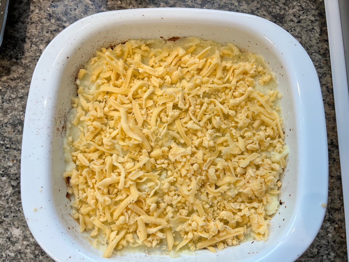Shredded cheese added to the top of mashed potatoes on Meatloaf Casserole Recipe.