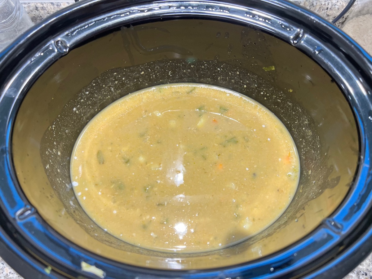 Coconut milk and cornstarch slurry mixed into other ingredients in the slow cooker for Crockpot Thai Chicken Curry recipe.