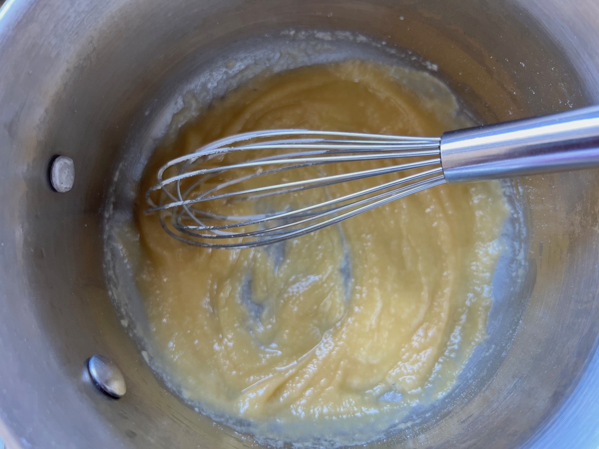 Whisk in a saucepan mixing the flour and butter for the roux for Broccoli and Chicken Lasagna recipe.