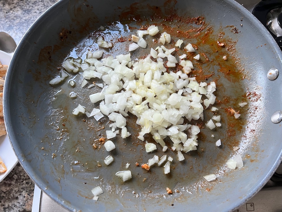 Diced onion added to the skillet the chicken was cooked in.