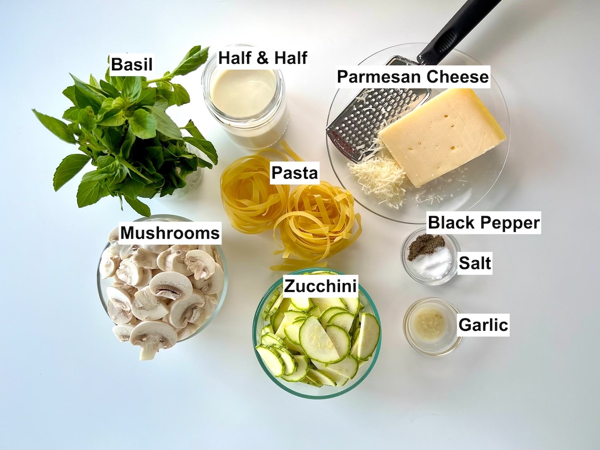 Ingredients shown are used to prepare pasta with zucchini and mushrooms.