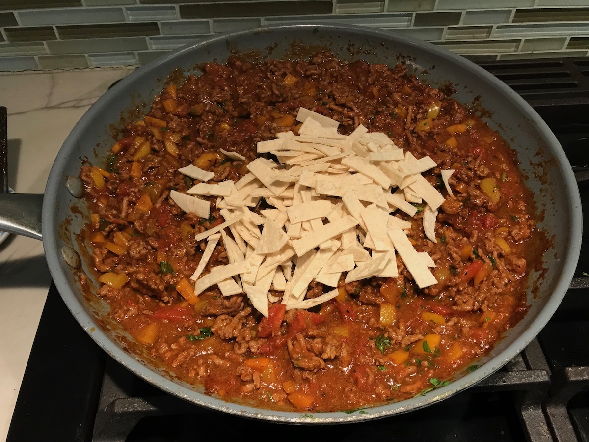 Tex Mex ground beef filling mixed with diced tomatoes and seasonings and corn tortilla strips added on top before being mixed in. This is for the Stuffed Peppers without Rice recipe.