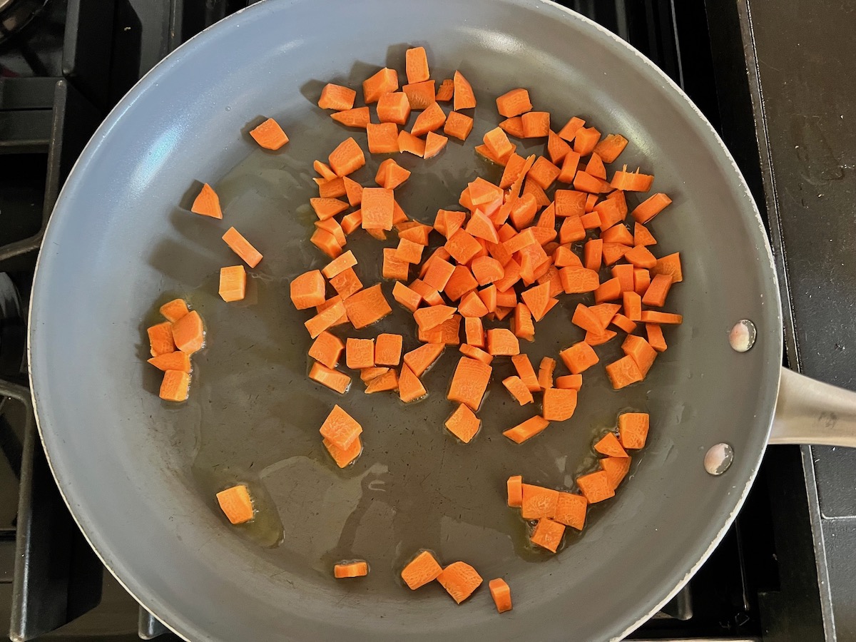 Carrots in skillet cooking for Ground Beef and Zucchini Casserole recipe.