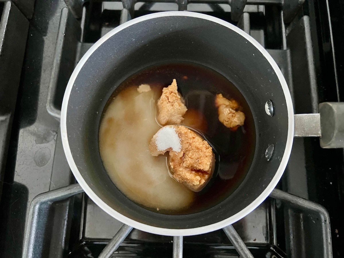 Soy sauce, Miso paste, granulated sugar, and rice vinegar in a pot before being mixed and cooked for the Glazed Miso Cod Recipe.