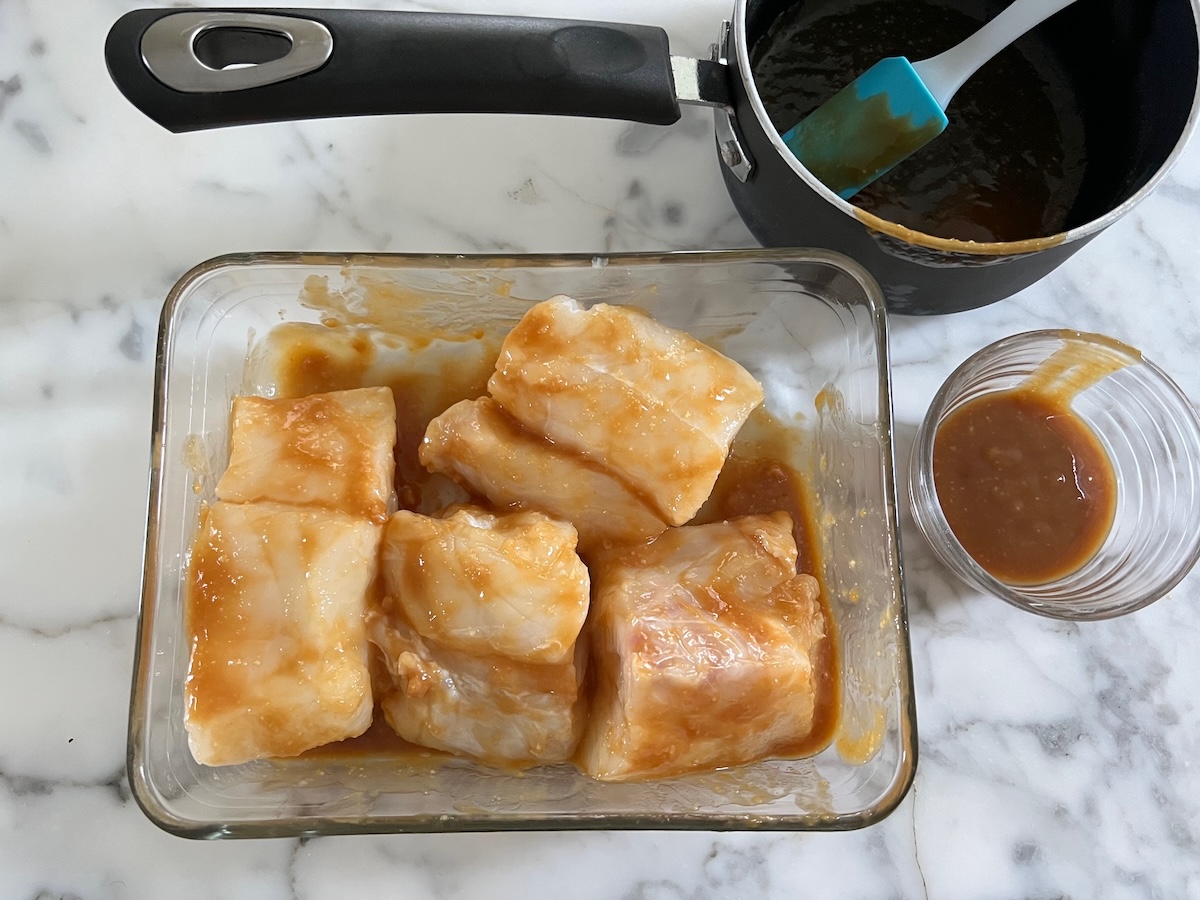 Four raw cod fillets marinating in the miso glaze for the Glazed Miso Cod Recipe.