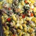 Sheet Pan Gnocchi, Italian Sausage, Broccoli Rabe, and Cherry Tomatoes golden brown with melted mozzarella on top.