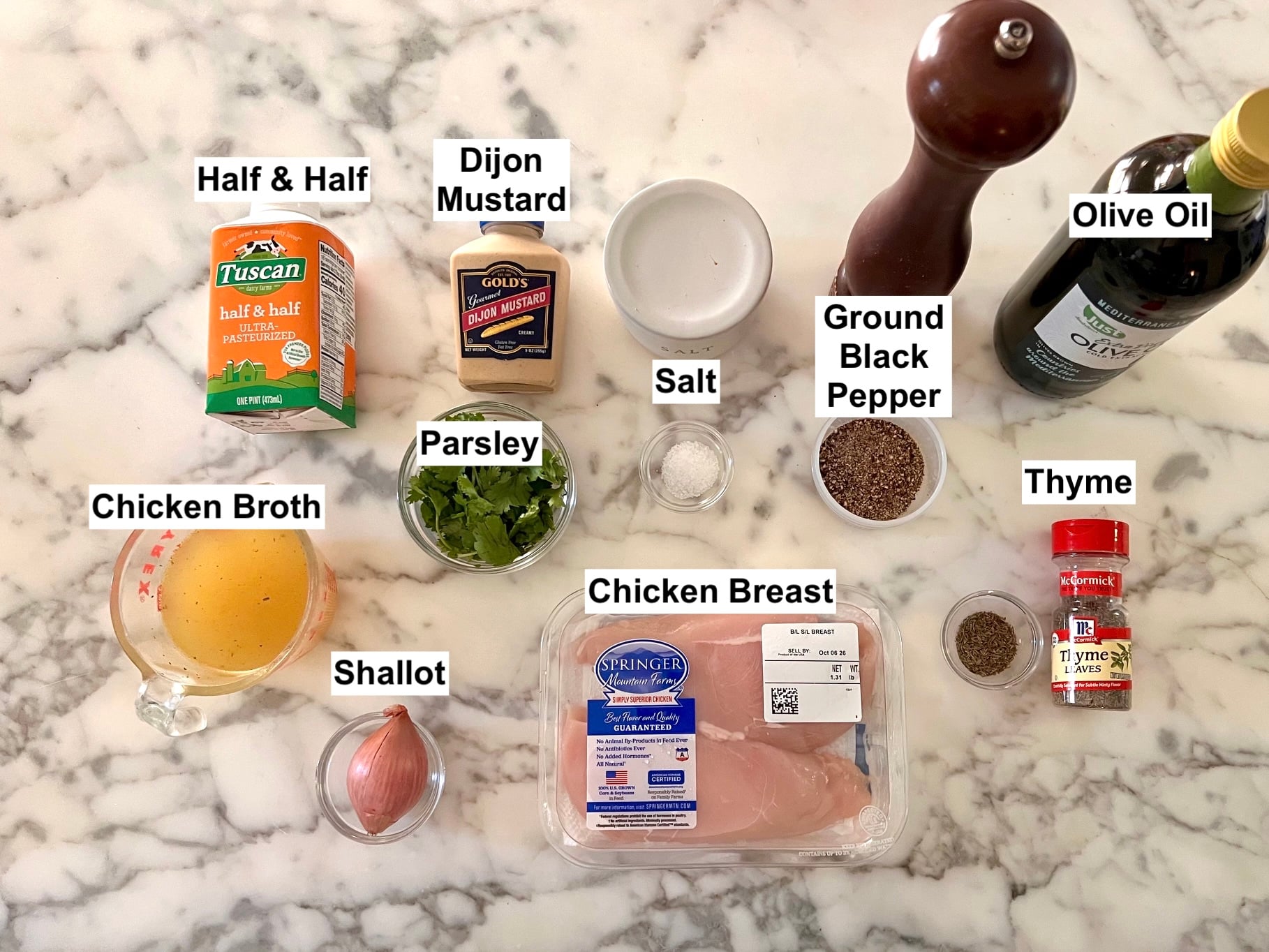 Labeled ingredients prepped and measured out or in bottles on the counter for this Chicken au Poivre recipe.