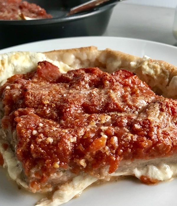 Slice of Chicago Style pizza with tomatoes on top.This Chicago Style Pizza is a lighter and healthier version, but still AMAZING! It still has all of the gooey mozzarella cheese, but uses homemade turkey Italian Sausage, that's so delicious!
