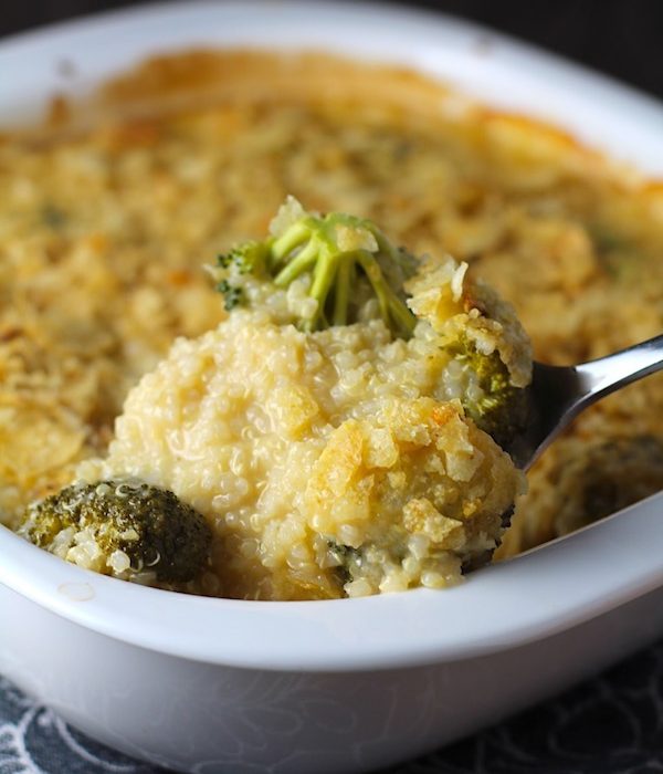 Spoon scooping Broccoli Cheese Quinoa Bake with potato chips on top. It's a comfy cozy casserole that's perfect to make ahead for a simple weeknight side or main dish.
