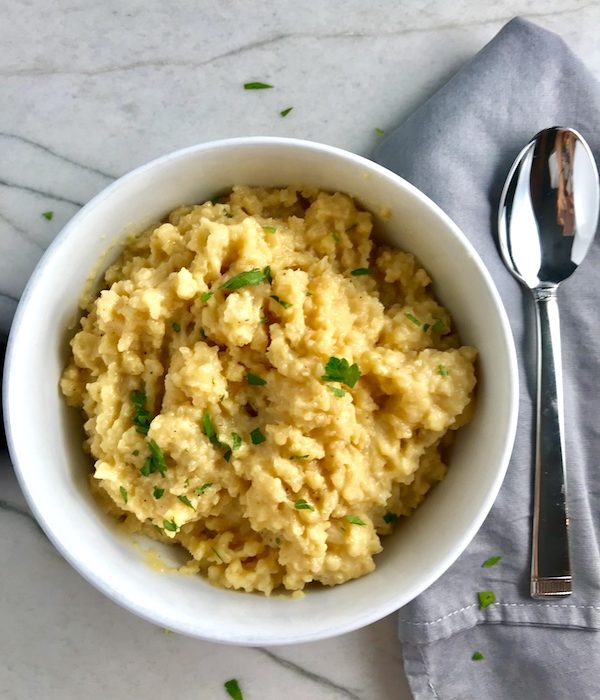 Welcome to my new favorite comfort food with a healthy twist: Cheesy Cauliflower Rice.  If Mac and Cheese met Cauliflower, fell in love and had a baby, it would be this Cheesy Cauliflower Rice. This recipe is so simple with just the flavors from the cauliflower - plus a few other things to help it come together.