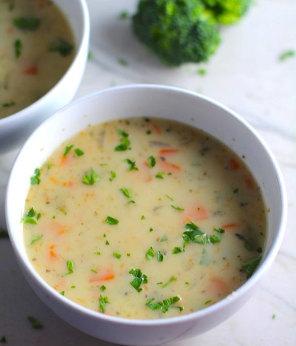 Slow Cooker Creamy Broccoli Soup in a bowl with second bowl in back. This is easy, comforting, and delicious! With Carrots, Broccoli, Onion, Garlic, and Oregano, this is one flavorful soup. And, there is no heavy cream, just milk and a little half and half mixed with cornstarch, so it's healthy and gluten free!