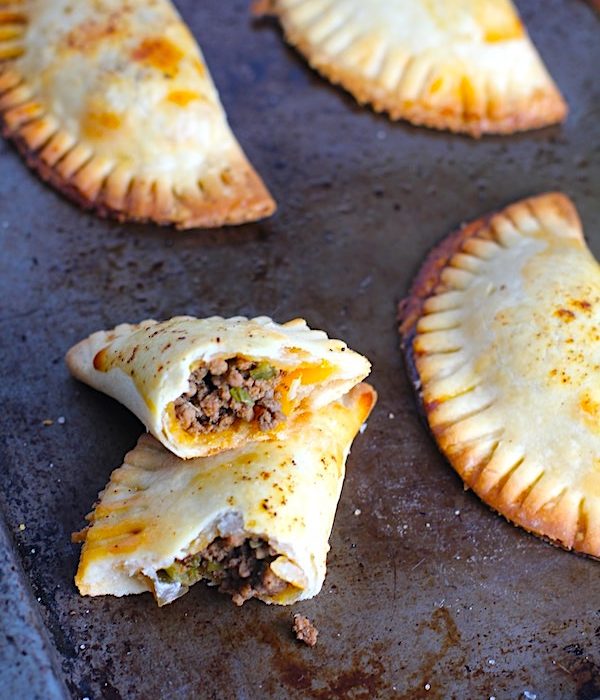 Ground Beef Empanadas on a pan. Flaky, buttery pastry on the outside with a savory, smokey, salty ground beef filling.