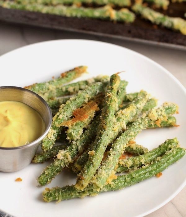 Crispy, crunchy, salty, and addictive!  These are my healthy Crispy Parmesan Green Bean Fries!  Such a great way to transform beans and add a new vegetable into dinner rotation. #vegetablerecipes
