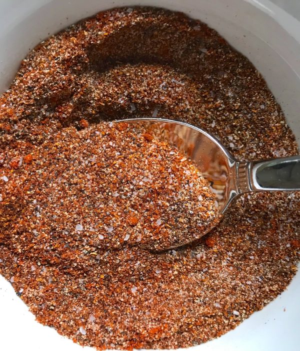 Cajun Seasoning in a bowl with spoon. It's smokey, spicy, salty, peppery, and adds fast flare to so many different foods.